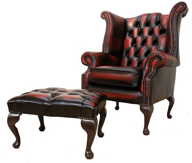 Product photograph of Chesterfield High Back Wing Chair Footstool Antique Oxblood Red Leather In Queen Anne Style from Chesterfield Sofas.