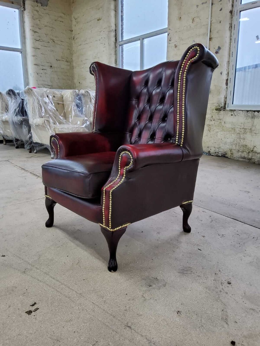 Product photograph of Chesterfield High Back Wing Chair Antique Oxblood Red Real Leather In Queen Anne Style from Chesterfield Sofas.