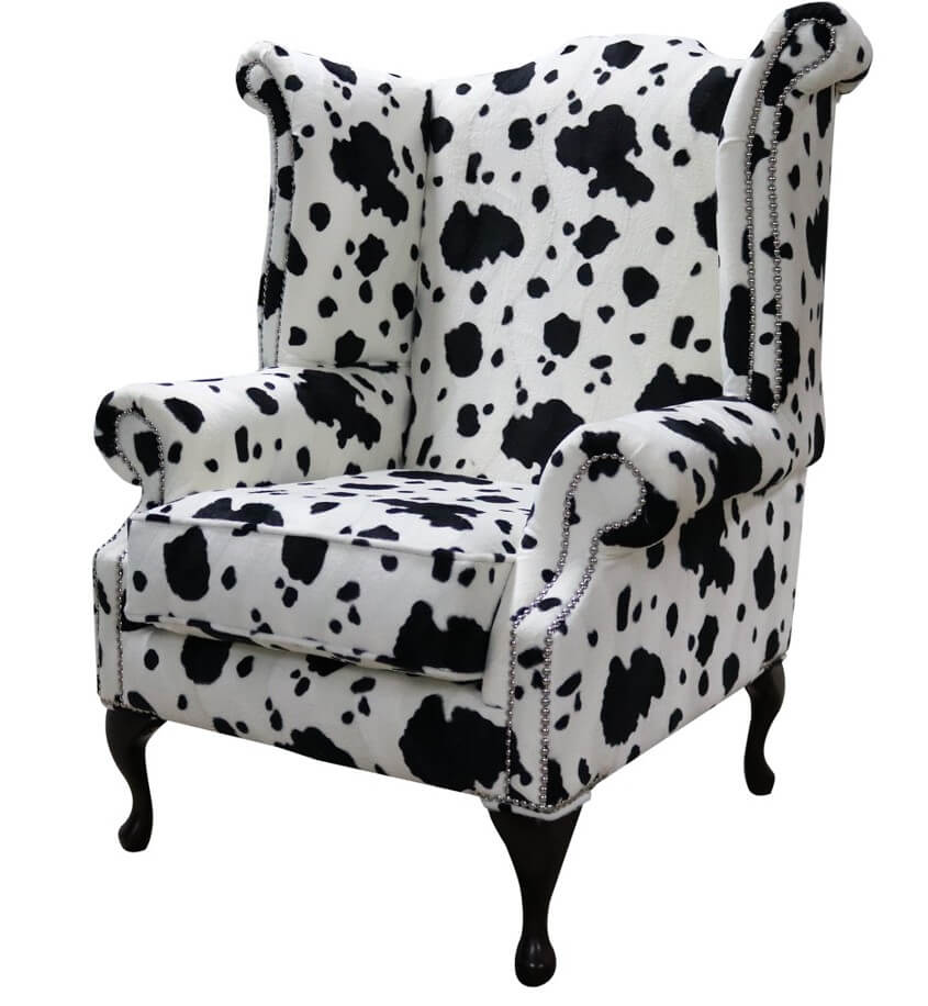 Product photograph of Chesterfield Saxon High Back Wing Chair Black Cow Animal Print Fabric In Queen Anne Style from Chesterfield Sofas.